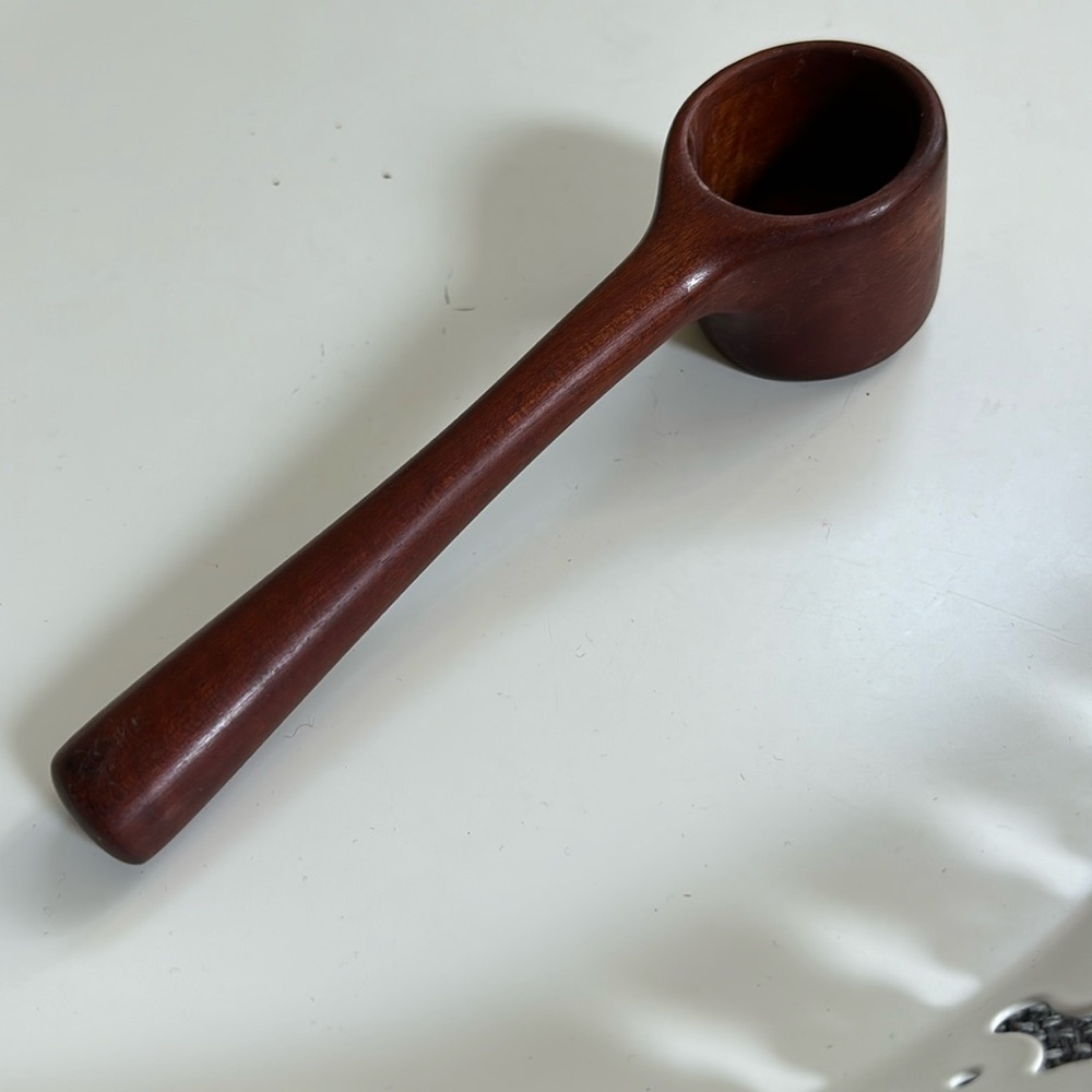 A hand-crafted Coffee Scoop with a comfortable long handle.